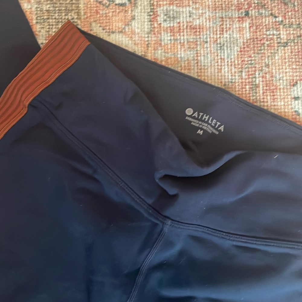 Athleta navy leggings with brown side detail